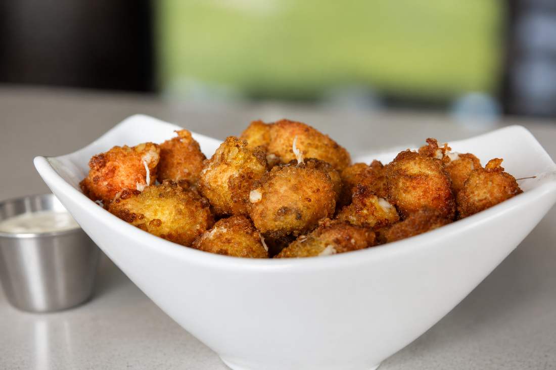 Bowl of fried Wisconsin cheese curds with dipping sauce