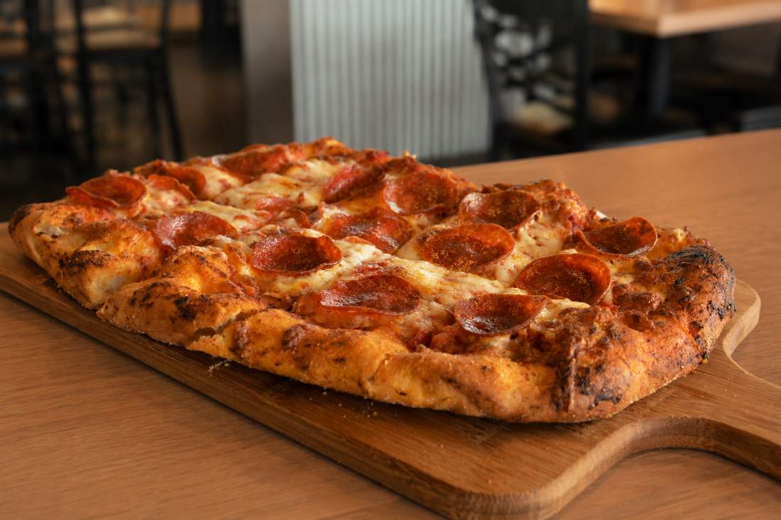 Pepperoni flatbread on a wood board